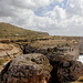 Miġra l-Ferħa - Ausblick von den Klippen nördlich oberhalb der Schlucht. Diese ist direkt im Vordergrund zu erahnen. Links sind einige Stufen des hinunter ans Meer führenden Steiges zu sehen. Auch die schmale (im Bild nach hinten führende) Seitenschlucht ist gut auszumachen.