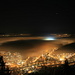 At night at the Felsenegg restaurant looking down to Adliswil. A stadium below the fog has the floodlights on