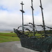 The National Famine Monument “is located near the Croagh Patrick Visitor Centre in Murrisk. This magnificent piece of sculpture by John Behan was unveiled by President Mary Robinson in 1997. It depicts a Coffin Ship with skeleton bodies and commemorates the anniversary of the Famine.” (from http://www.croagh-patrick.com/activities)