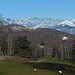 Dall'altra parte campo da golf e, in lontananza, cime della Valgrande. Visibili anche da qui gli ecomostri della Motta Rossa