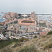 Im Aufstieg zum Tête de Chien - Blick auf Monacos Stadtbezirk Fontvieille, der sich weitgehend auf aufgeschüttetem Gelände befindet. Links davon ist der Port de Fontvieille zu sehen, rechts der Port de Cap d'Ail, welcher bereits zu Frankreich gehört. Mittig ist das Stade Louis II (Leichtathletik- und Fußballstadion) zu erkennen.