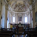 L'interno dell'abbazia dell'Acquafredda. Dietro l'altare si vede la tela del Fiammenghino (Giovanni Battista Della Rovere) che lavorò qui nel 1621.