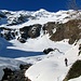 dopo aver risalito il pendio su neve ghiacciata ed aggirato le rocce dei Cogni ci troviamo nella parte bassa dell'Alpe di Croslina (nella foto a dx), valicando  il Piumogna ed entrando nel Böc di Comasne proprio di fronte a noi con la sua cascata ghiacciata 