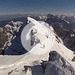 Salita sci alpinistica effettuata il 13/03/2015<br />Dislivello: 1770m<br />Lunghezza: 17,5km<br />Difficoltà: BSA (sci), D<br />Esposizione. N<br /><br />Partenza con gli sci dal lago superiore di Fusine (941m) prima dell'alba seguendo la strada forestale per l'Alpe del Lago (sentiero n. 514-515) e diretti verso la valle della Lavina. <br />Dopo circa 1,5km si devia a destra sul greto del torrente che, prima ampio, si restringe gradualmente e poi si addentra nella boscaglia. All'inizio si procede quasi in piano e la pendenza aumenta gradualmente.<br />Fuori da bosco,rischiarato dall'alba, appare ben evidente il percorso che conduce alla Forcella della Lavina. Le pendenze aumentano fino a superare i 30° nel finale. Il fondo di neve dura costringe ad procedere con i ramponi nell'ultimo tratto tra le rocce che porta in forcella (2055 m).<br />Qui il Mangart appare in tutta la sua grandezza e nasconde il sole del primo mattino. Si procede verso la ferrata e l'itinerario diventa alpinistico. Sci posizionati sullo zaino e fuori le piccozze.<br />Il traverso appare in buone condizioni e la neve offre un buon sostegno. Consigliata una corda per sicurezza.<br />Sulla cresta finale si trovano anche tratti con neve molto dura e compatta che obbligano a procedere con attenzione. Il Tricorno (Triglav) e lo Jalovec accompagnano la parte finale della salita.<br />In cima la neve abbonda e la croce di vetta è per metà sommersa.<br />Gran vista sulle altre alpi Giulie - Canin, Jof Fuart, Jof di Montasio... -, dolomiti - il solito Antelao, le Tofane, .. -, il Coglians, i Tauri, ecc...<br />Rientro per lo stesso itineraio di salita.<br /><br />------------------------------------<br /><br />Mangart (Julian Alps) - Winter ascent from Fusine Lakes<br /><br />Date: 13.03.2015<br />Vertical drop: 1770m<br />Length: 17,5km<br />Difficulty: BSA (skiing), D<br />Exposure: N<br /><br />Departure on skis from the upper lake of Merger (941m) before dawn along the forest road to Alpe del Lago (path n. 514-515) and heading towards the valley of Lavina.<br />After about 1.5 km turn right on the river bed that, before large, gradually narrows and then goes into the bush. At the beginning the path is almost flat and the slope increases gradually.<br />Outside the forest, lit from dawn, appears very obvious route that leads to the Forcella of Lavina. The slopes rise to over 30 ° in the final. The hard snow forces to proceed with crampons last stretch between the rocks leading into the fork (2055 m).<br />Here the Mangart appears in all its grandeur and hides the early morning sun. From this point the route becomes mountaineering. We place the skis on the backpack and use ice axes.<br />The traverse is in good condition and the snow provides a good support. Recommended a rope for safety.<br />On the final ridge are also traits with snow very hard and compact requiring to proceed with care. The Triglav (Triglav) and Jalovec accompany the final part of the climb.<br />On top of the snow abounds and the summit cross is half submerged.<br />Great views of the other Julian Alps - Canin, Jof Fuart, Jof Montasio ... -, Dolomites - the usual Antelao, Tofane, .. -, Coglians, the Tauern, etc ...<br />Return for the same itinerary.