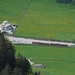 Die Appenzller Bahn fährt nach Wasserauen, dahinter die Talstation der Ebenalpbahn