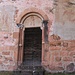 Il portale di Santa Maria Assunta a Torello. Timpano semicircolare su mensole probabilmente gotiche e una coppia di colonne con collaretti e capitelli ornati da gemme. Affresco della Vergine fra un santo ed un vescovo.