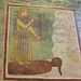 San Giulio che raggiunge l'isola sul Lago d'Orta navigando sul suo mantello. Qui giunto la libererà dai serpenti che la infestavano, qui rappresentati sul lato destro dell'affresco.
