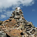 The cairn at the summit of Piz Albana. Someone left their white shirt there...