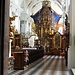Sullo sfondo si vede l'imponente altare maggiore con l'albero della vita, capolavoro di Bartlime Steinle del 1610 -1613. L'opera è in legno scolpito e dorato e sui rami trovano posto 84 statue lignee di santi.