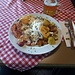 <b>La camminatina è preceduta da un pasto a base di Spiegeleier mit Speck und Bratkartoffeln, consumato al Panoramarestaurant della stazione a monte della funivia. </b>