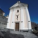 <b>Oratorio di Santa Croce a Spruga.<br />Sopra il portale, il Cristo in bronzo di Nag Arnoldi (Locarno, 18 settembre 1928), donato all'oratorio nel 1966.</b>