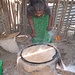 Injera-Backen auf Tonplatten-Ofen. Aus dem Eimer wird der 3 Tage angesetzte Sauerteig aus Teff und Wasser auf die Tonplatte aufgetragen und ca. 5 Minuten gebacken