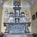 L'altare con paliotto in scagliola. In alto una bella Natività, sotto un affresco risalente al XIII secolo ed appartenente alla chiesa primitiva, raffigurante una santa. 