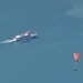 Looking down to Walensee, a boat and a paraglider