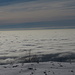 Sotto la coltre di nubi, la Pianura Padana.