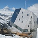 die bekannteste SAC Hütte in den Alpen. Monte Rosa Hütte und dahinter das Matterhorn mit Mütze und Schal.