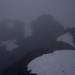 Bei starkem Schneeregen taucht der Gipfel der Schrundbalm (2035m) im Nebel auf.
