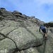Damiano impegnato sulle facili rocce finali prima della cima.