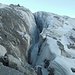 Am linken Rand des Gletschers steige ich über einen großen Steinblock über das Ende dieser Spalte.
