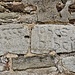 Iscrizioni lapidee in facciata, una pietra riporta una data, forse 1421, l'altra il nome Jonas.