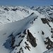 Piz Traunter Ovas - view from the summit of Piz Surgonda. A group of skiers are on the way up.