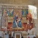 Parete nord<br /><br />    Madonna del latte, seduta in trono con a fianco San Grato e San Rocco (dipinto datato 1488 e firmato da Giovanni Antonio Merli