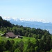 Bergwirtschaft Poo-Alp mit den verschneiten Alpen