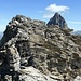 Between the summit of Piz Cagniel (2975 m according the current online maps) and P.2970 (which was considered the summit on maps from before 2015). Here it is necessary to leave the ridge and make a detour in the east flank (T4+). The main reason for the detour is the 3-4 m vertical wall in the foreground here. Climbing is not an option, cause the stones are either loose or brittle. This photo is the view back after I returned to the ridge.