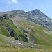 For the ascent I used the couloir on the left side as described by [u ivo66] (T3+, left red line). For the descent I came down through a short but steep couloir (T4-, as indicated by the middle red line), and then across the grassy hillside (T3).