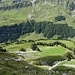 Bei der letzten gut erkennbaren weiss-blauen Markierung geht es auf dem Grasrücken(rechts von der Bildmitte südlich des tiefen Einschnittes) hoch und nicht dem einladendem breiten Weg folgen. Der Aufstieg folgt auf der südlichen Seite der Transportseilbahn<br />