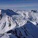 Westgrat vom Gipfel aus gesehen. Rechts sieht man zwei Tourengeher im steilen Anstieg zum Skidepot auf dem Grat.