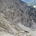 Rückblick in die Nordwand, die aus dieser Perspektive flach und klein wirkt. In Bildmitte unten der wichtige Grasflecken mit den Latschen