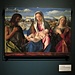 "Madonna col Bambino tra San Giovanni Battista ed una Santa" di Giovanni Bellini. Alle spalle delle figure si riconoscono le Dolomiti.