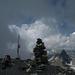 Gipfelbucheintrag auf dem Muttler im Wolkengrau - der Stammerspitz ist schon weit unten