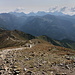 Kopa Kondracka / Kondratova kopa - Ausblick ins dunstige Gegenlicht. Im Hintergrund sind etliche Gipfel der Hohen Tatra zu erahnen: Von Świnica (links) bis Kriváň (rechts). Der hier sichtbare Weg verläuft entlang des Granzkammes von Polen zur Slowakei.