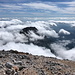 Grintovec - Ausblick am Gipfel. Im Süden ragt der Kalški Greben (2.224 m) aus den Wolken.