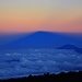 Auf dem Gipfel vom Kilimanjaro / Kibo - Uhuru Peak (5891,775m).  <br /> <br />Kurz nach Sonnenaufgang legt sich der Schatten vom Kilimanjaro über die afrikanische Landschaft und das Wolkenmeer.  Der Berg im Schatten ist der Mount Meru (4562m).