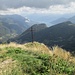 La croce sul Sasso Gordona, posta leggermente più in basso rispetto alla cima, sul versante verso la Val d’Intelvi. Sullo sfondo il Lago di Como con il promontorio di Bellagio e il Monte Legnone.