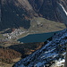 The small summit cross on the main summit of Dosso di Fuori, the village of Rèsia / Reschen down at the lake