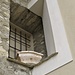 Su una finestra cieca della parrocchiale di San Siro a Bruzella si trova questo pregevole manufatto in marmo d'Arzo.
