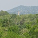 Dalla vegetazione spunta il campanile della chiesa di Luvinate.