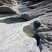 Wie an einer Perlenschnur aneinander gereihte Gletschertöpfe im Val Maliens