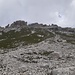 Unter der rechten Schurre: Man sieht gut den breiten Turm links der Bildmitte, auf dessen rechten Rand der Aufstieg über den Grashang zielt.