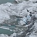 Mit weissem Vlies abgedeckte Eisgrotte am Rhonegletscher - ein trauriges Bild und zugleich der Verschandelung der Landschaft. Seit 2004 verwendet man solche Planen, um das Schmelzen bei der Eisgrotte zu verlangsamen