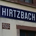 Informationstafel am ehemaligen Bahnhofsgebäude von Hirtzbach.
