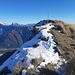 Gipfelkreuz des Monte Serva. Links im Bild der angezuckerte Col Nudo