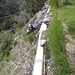 Vor nicht allzu langer Zeit wurden hier offenbar die alten und beschädigten Rohre vor Absturz gesichert. Allenfalls um einen Absturz auf den darunterliegenden Wanderweg zu vermeiden?
