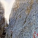 Der Steig verläuft zunächst auf dem Schuttband bis zu den Westabstürzen der Rosengartenspitze. Wo der Steig die Felsen erreicht, beginnt die Kletterei. Zunächst ging es auf Bändern frei hinauf, ungesicherte Kletterei im ersten und zweiten Grad. Dann erreichten wir in leichter, freier Kletterei eine markante, schmale Scharte an einem scharfen Felszacken, in der rechts am Fels das Rifugio Santner angeschrieben stand.