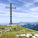 Am Gipfel des [https://www.atterwiki.at/index.php/Brunnkogel Brunnkogels (1708 m)] mit seinem 18 m hohen Gipfelkreuz. Bemerkenswert schön gefertigt ist es: in der Gitter-Konstruktion des Kreuzes sind aus Stahlblech gefertigte Silhouetten von Aurachtaler Berufsständen zu sehen sowie ein knieender Soldat, der seinen in den Weltkriegen gefallenen Kameraden gedenkt. Es ist die Rekonstruktion eines 2013 durch Schneelast zerstörten Kreuzes.