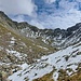 Oben an der Rippe: Der Talschluss ist erreicht. Der Weg steigt vom markanten Felsen im Mittelgrund die Grasflanke links aufwärts.